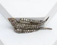 Swallow brooch, probably Russia, 14kt white gold, silver, old-cut diamonds, ruby cabochon as eye, approx. 13.3 g, one stone missing