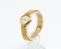 Chopard, montre-bracelet femme, or jaune 18 carats, boîtier rond avec cadran blanc et index romains en or, signature "Chopard / Geneve / SWISS MADE", lunette à "12" et "6" heures avec chacune un brillant d'env. 0.15 ct., fond vissé...