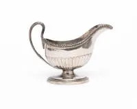 Classicist sauce boat, 18th/19th c., maker's mark "R.M / R.H", other hallmarks erased, elegantly curved form with acanthus handle and lower half fluted body, on oval base, 13.5 cm high, approx. 330 g