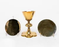 Neo-Gothic chalice with two patens, probably German or Belgian, 2nd half 19th c., probably silver, gilt, partially coloured enamelled; on wide six-lobed curved foot with openwork quatrefoil gallery; the surface with fine...