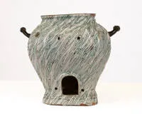 Large faience rechaud / brasero, probably Eastern France or Brussels, 2nd half 18th c., bulbous body flattened on four sides on a recessed base; whitish glazed faience with green and manganese marbled decor, the wall with...