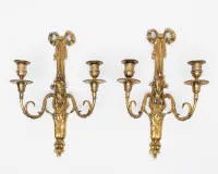 Pair of classicist wall appliques / "Appliques grotesques", Louis XVI, France, circa 1780, gilt, two lights each with crowning bow, H. 42 cm, somewhat rubbed