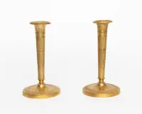 Paire de candélabres Empire / bougeoirs, France, début 19e s., bronze doré, décor finement ciselé, fût conique élancé sur base ronde, H. 19 cm