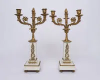 Pair of girandoles / candlesticks, Empire, France, 1st half 19th c., fire-gilt bronze, three-armed with rich Empire decoration on white alabaster bases, h. 43 cm, ø 23 cm
