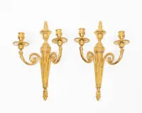 Pair of neoclassical wall appliques / wall lights, Louis XVI, France, circa 1780, gilt, each two-light with garland-shaped arms on fluted base, 44 x 27 cm