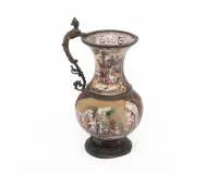 Enamel jug with fine painting and figurative handle, Vienna, late 19th century, enamel on copper, 18 cm high, outside rural scenes in four panels, inside fine decorative painting with mascarons and fruit garlands, various losses,...