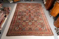 Bibibaff-Bakhtiari, Iran, 1st third 20th c., nine rows of 15 square fields with rich floral motifs, nine borders with flowers, tendrils and palmettes, approx. 5.23 x 3.70 m, edge partly damaged, one corner with reduced pile, overall...