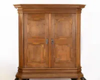Hall cupboard, Hesse, around 1800, oak, two-door cabinet on tall, wide, moulded plinth, doors with shaped panels, chamfered, wavy corner pilasters. Tall, matching, strongly projecting top, smooth sides, approx. 209 x 196 x 72 cm, few...