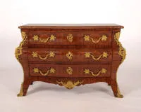 Representative commode, Régence, France, 1st half 18th century, strongly bombé body with three drawers above curved apron and splayed feet, rich gilt mounts with side mascarons and acanthus decoration, red marble top...
