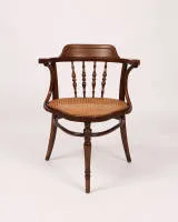 Writing armchair, Jacob & Josef Kohn, Vienna, around 1900, bent oak, seat with Viennese cane, body with armrests, backrest with baluster spindles, original manufacturer's label and stencil underneath, H. 82 cm, seat with minor...