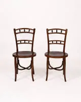 Pair of café chairs, probably Thonet, circa 1900, bentwood, each round seat with ornamental painting, backrest with 6 ebonized balusters, H. 88 cm, restored