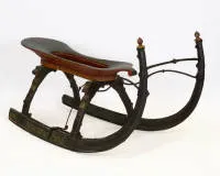 Alpine sledge / horse-drawn sleigh, probably Austria, around 1800, wooden runners with iron fittings and polychrome finish, curved seat, raised runners with baluster finials, approx. 80 x 150 x 60 cm, finish with losses, signs of age