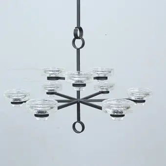 Brutalist 9-arm candle holder made of iron with inset candle holders.
