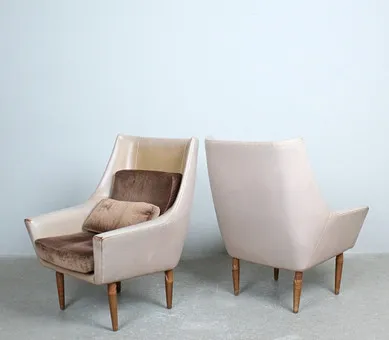 Pair of armchairs with leather upholstery and velvet cushion.