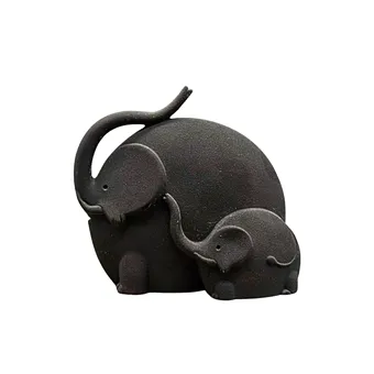 Monoli. Stoneware elephant figurine with matte black smoke-fired surface.
