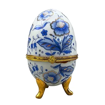 PORCELAIN EGG WITH HINGED LID AND BLUE DECOR.