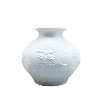 AK Kaiser biscuit porcelain vase with floral decor.