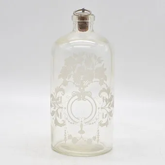 Bouteille française avec bouchon, décor de médaillon et fleurs, gravée, fin 19e siècle.