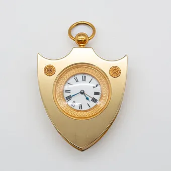 CHARLES VICTOR HOUR. Empiretyylinen upseerikello 1800-luvulta, herätystoiminnolla, pronssia ja messinkiä, tulikullattu, emalitaulu.
