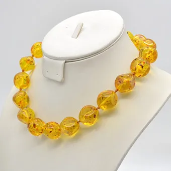 Yellow amber necklace, leaf inclusions, individually knotted, circa 1950.