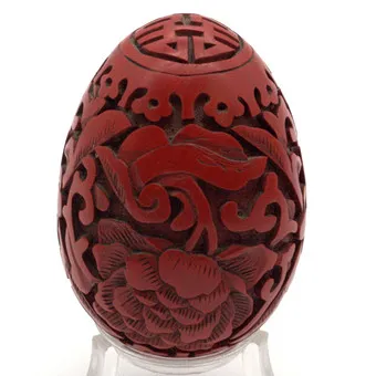 CHINESE CARVED RED LACQUER OBJECT IN EGG SHAPE, CIRCA 1980.