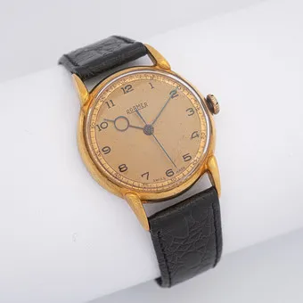 Montre-bracelet vintage ROAMER, remontage manuel, cadran cuivré, boîtier doré, aiguilles bleutées, années 1960, bracelet en cuir.