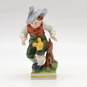 ERNST BOHNE & SÖHNE. "BOY WITH CHICK", THURINGIAN PORCELAIN FIGURE, POLYCHROME, GERMANY, CIRCA 1950.