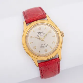 VINTAGE WRISTWATCH BY URWA, GOLD-PLATED CASE, GOLDPLATED, AUTOMATIC, 25 JEWELS, SHOCKPROOF, ANTIMAGNETIC, WATERPROOF, 1950S, RED LEATHER STRAP.
