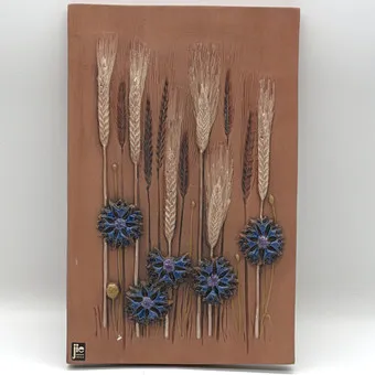 AIMO NIETOSVUORI. FOR JIE GANTOFTA, CERAMIC WALL RELIEF, SWEDEN CIRCA 1960, DEPICTING AN AUTUMNAL MOTIF OF RYE EARS AND BLUE CORNFLOWERS.