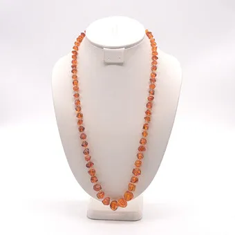 AMBER NECKLACE, POLYHEDRAL BEADS, POLISHED SURFACE, SMALL TO LARGE, GILT CLASP, CIRCA 1950, APPROX. 71 CM.