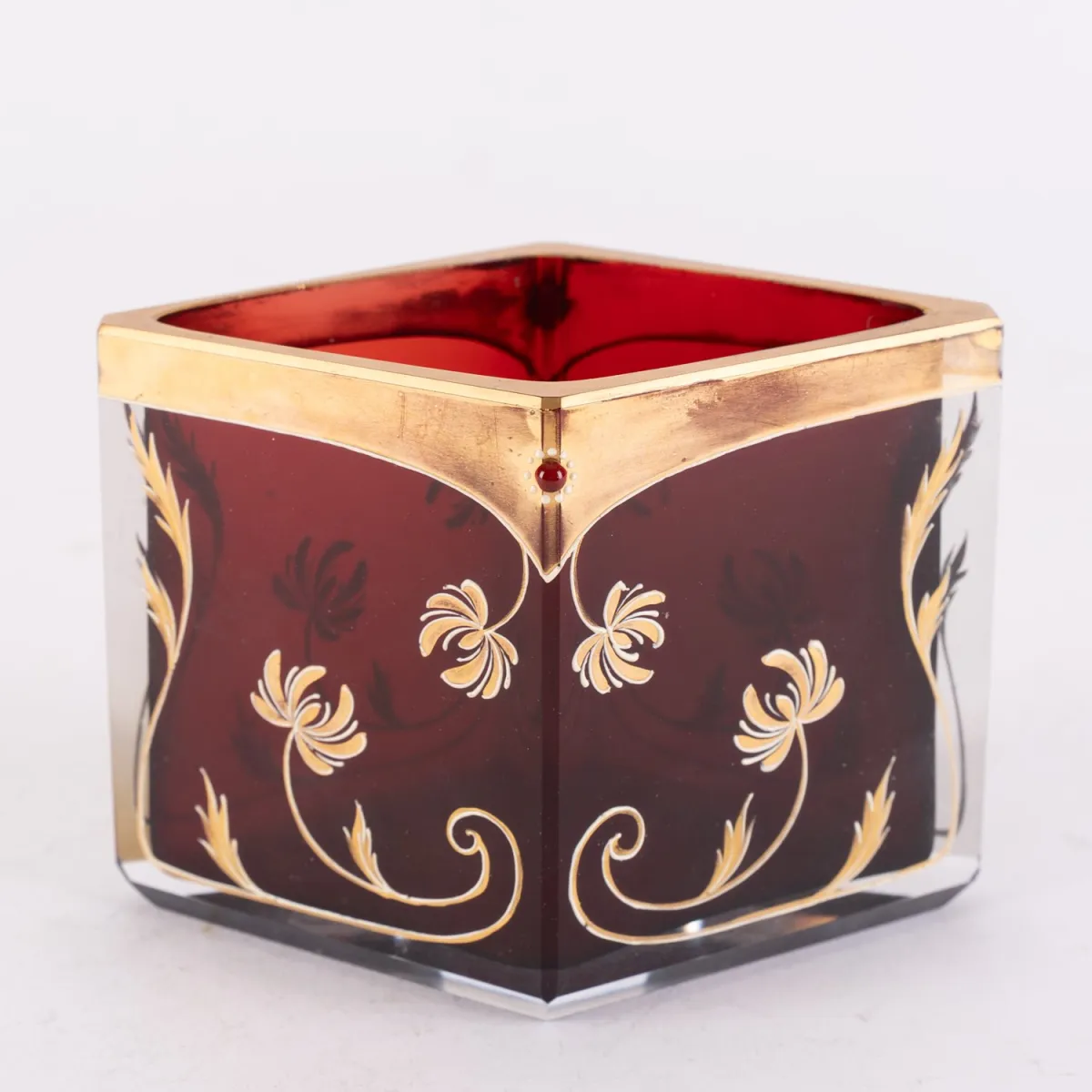 Decorative ruby red diamond-shaped glass vase with elaborate gold enamel decor, red applied lengthwise and centrally...