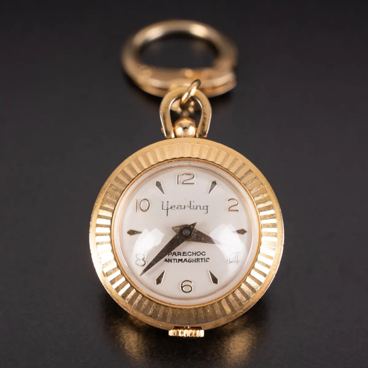Yearling, spherical pocket watch on small link chain. Case diameter approx. 29mm, movement starts running, untested, metal…