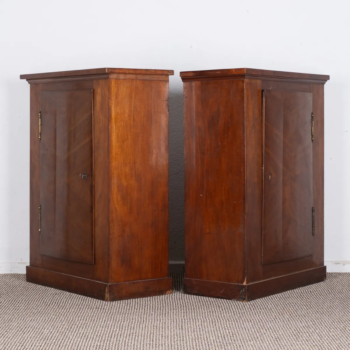 Pair of neoclassical column cabinets. Solid and veneered mahogany, circa 1800. Pair of single-door cabinets with slight p…