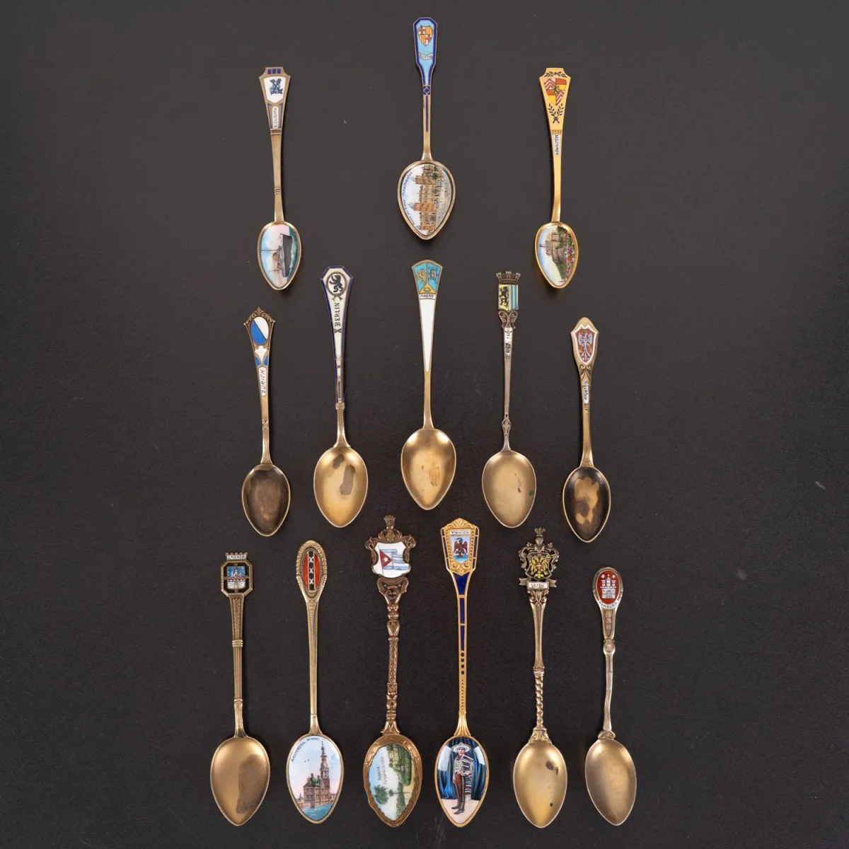 14-piece collection of various (partially) enamelled small spoons. Mostly silver, partly gilded, vari…