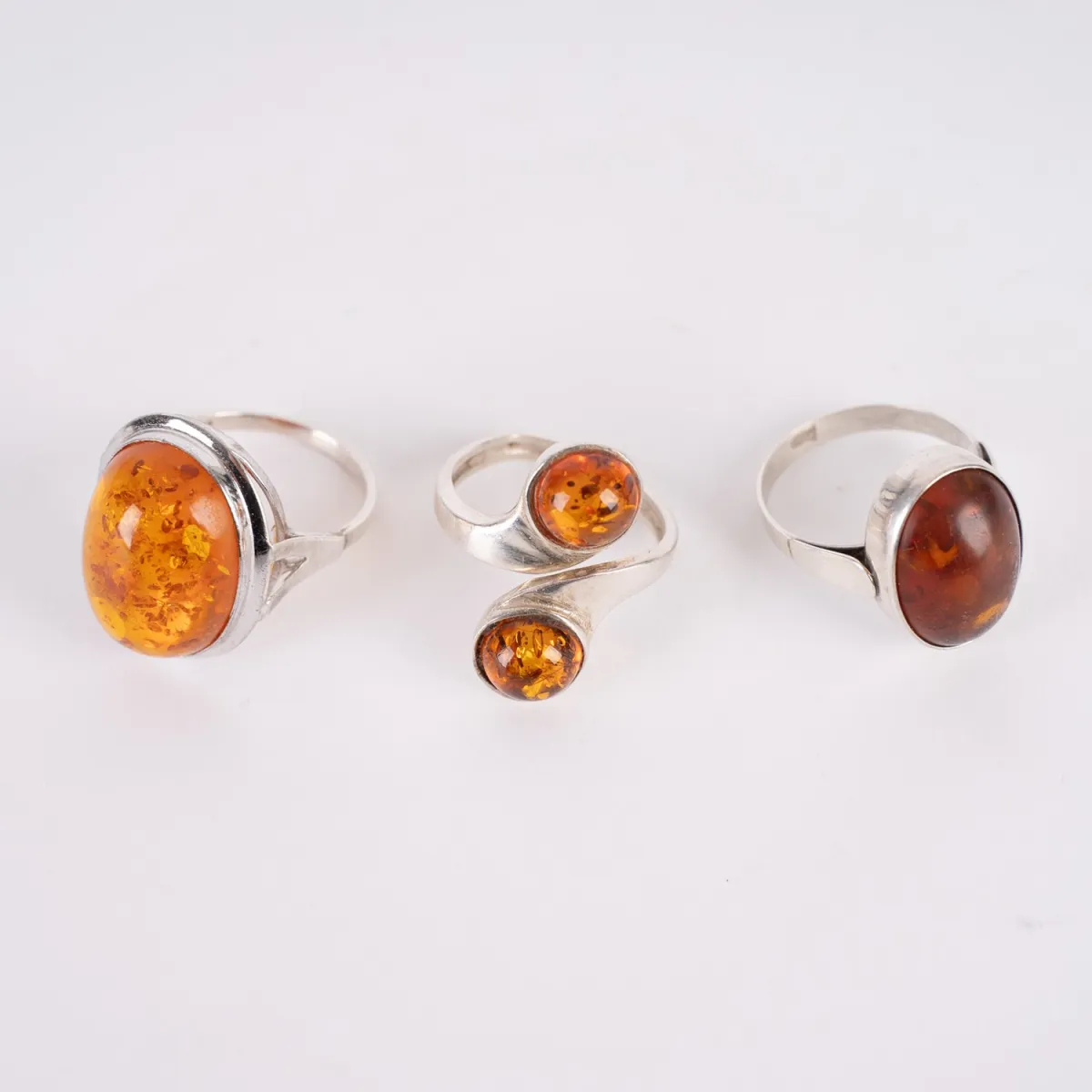 3 amber rings, silver, different sizes, 1 ring slightly bent, otherwise good condition.