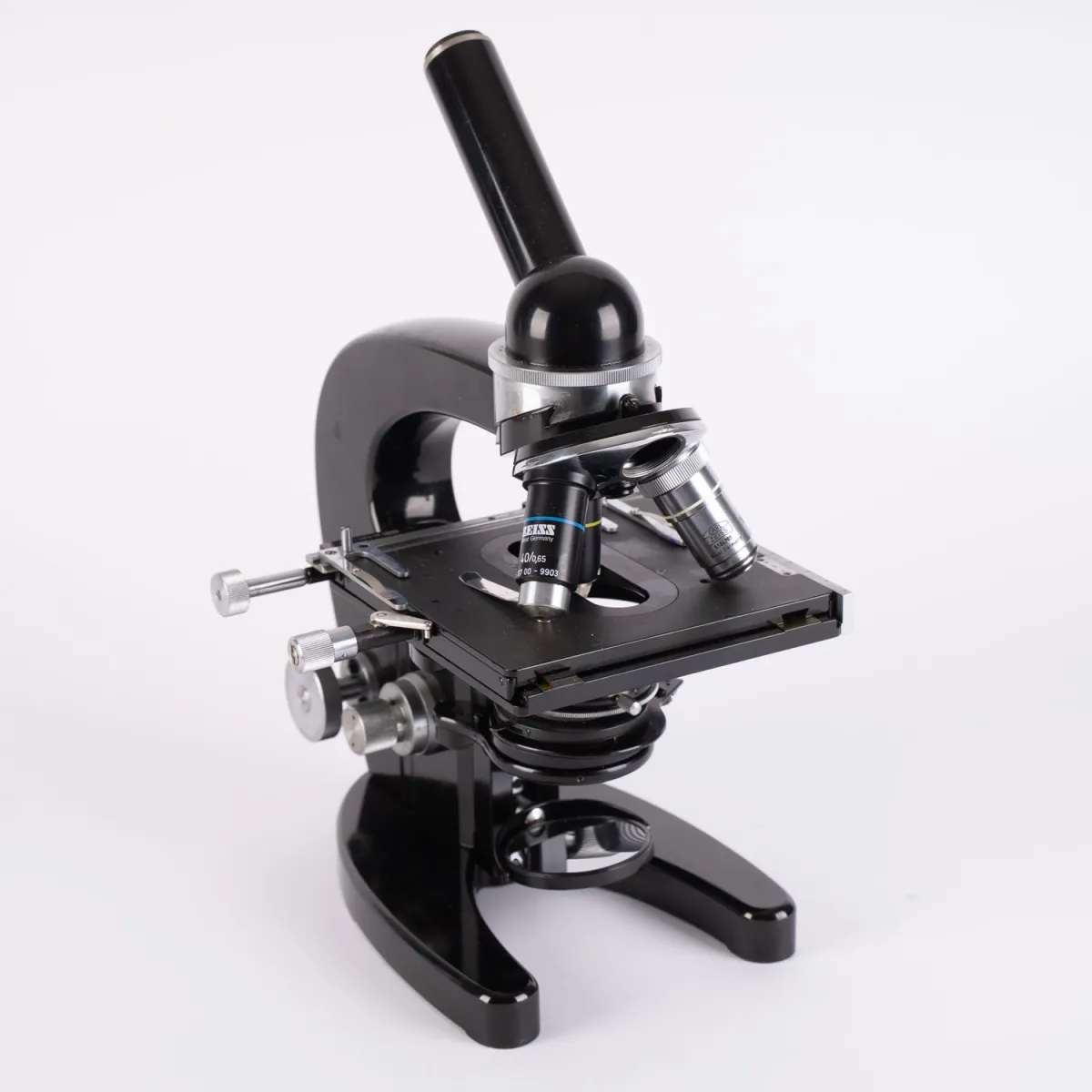 Large microscope in wooden case with various accessories, revolving nosepiece, swiveling and height-adjustable.