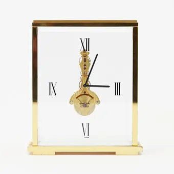 SWIZA. Table clock / alarm clock, model 'Athena', manual winding, 8-day power reserve, brass, glass, 20th century, Switzerland.