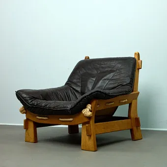 MAISON REGAIN. Attributed, brutalist armchair / lounge chair, oak, leather, 1970s, France.