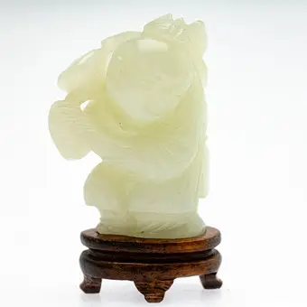 Boy with lotus flower, jade, China, late Qing Dynasty.