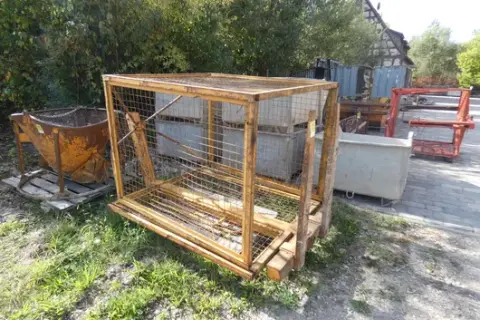 Crane pallet fork with mesh safety basket