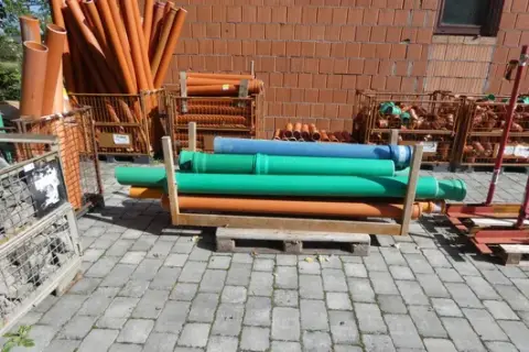 Pallet with wooden frame and plastic pipes, incl. KG pipes, green, orange and blue