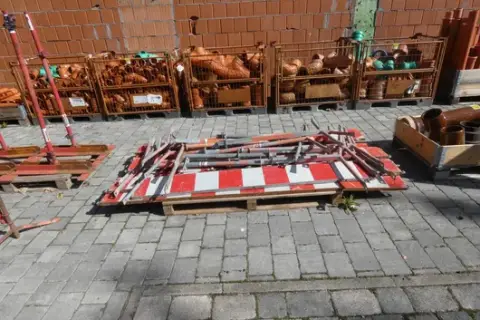 Lot of red-white barrier fences with supports and tubes