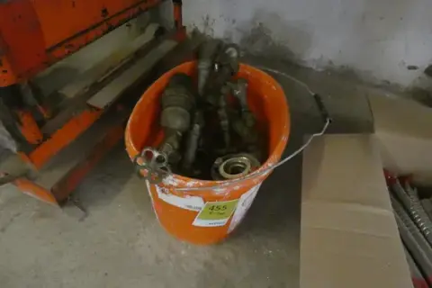 Bucket with assorted water fittings, valves, Storz couplings and drain cocks