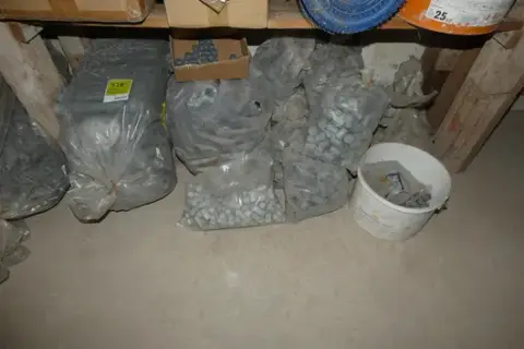 Lot of bags and buckets with plastic spacer tubes and cones for formwork