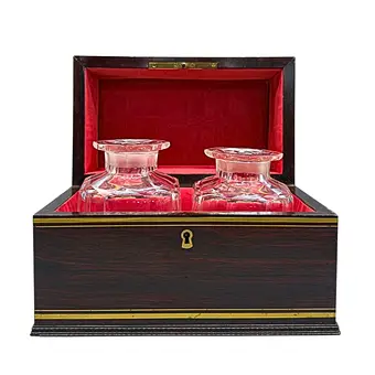 Wooden spirits case with two glass decanters - dated 1854.