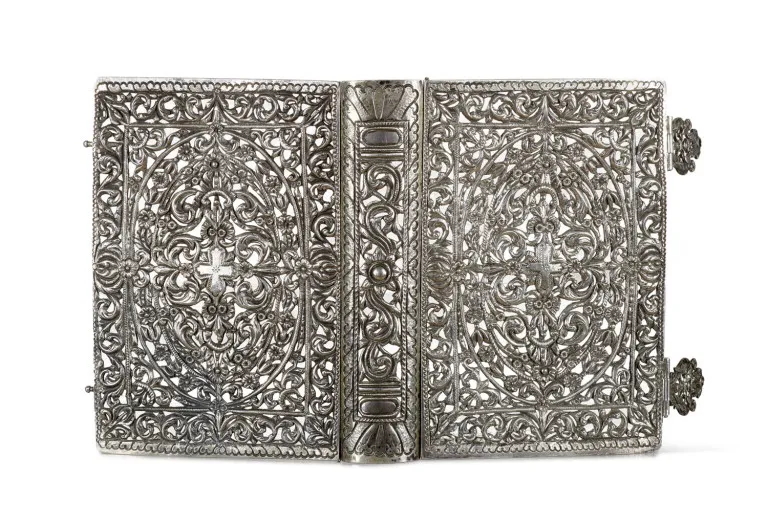 Elaborate book cover with highly filigree ornamentation and a central cross on both covers