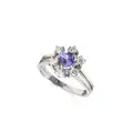 White gold flower entourage ring with tanzanite solitaire and brilliants.