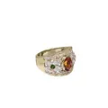 Bandring met strikken van diamant en een centrale oranje saffier.
