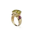Yellow gold ring with yellow-green quartz solitaire and red tourmalines.
