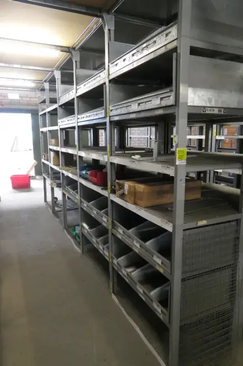Mixed lot of construction, electrical and DIY materials, including product dividers and metal fittings, with storage boxes
